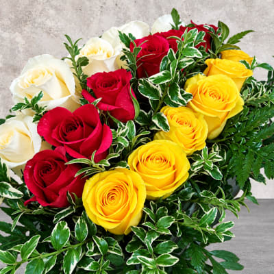 Bouquet of red, white, and yellow roses with variegated greenery
