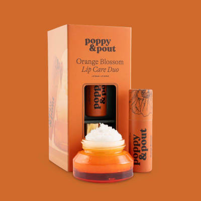 Orange lip care gift set with balm, scrub, and jar in branded packaging