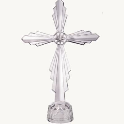 Clear crystal cross on a small base against a white background