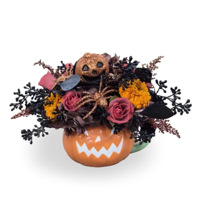 Halloween bouquet in a jack-o'-lantern mug with pink roses and glitter accents