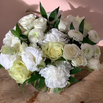 White roses and chrysanthemums arranged in a low bouquet