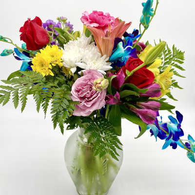 Mixed bouquet of colorful flowers in a glass vase