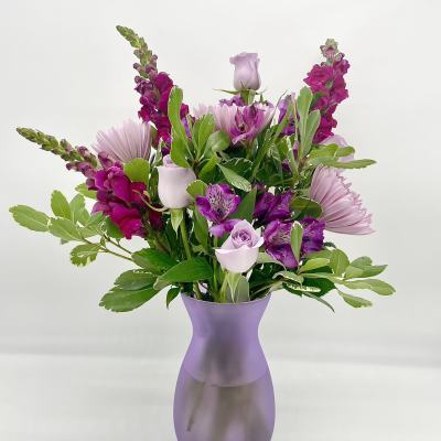 Lavender and magenta bouquet in a purple vase