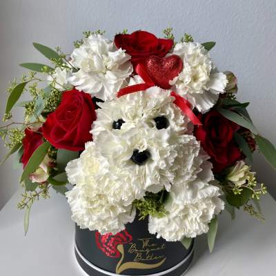 Red roses and white carnations arranged in a black hat box with a heart accent