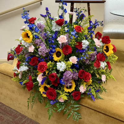 Large mixed flower arrangement with red roses and sunflowers
