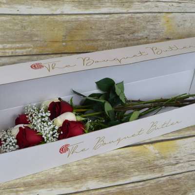Red and white roses in a white bouquet box