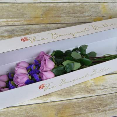 Lavender roses in a white bouquet box