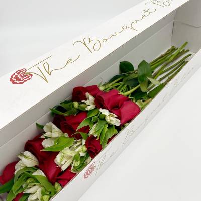 Long box of red roses and white flowers