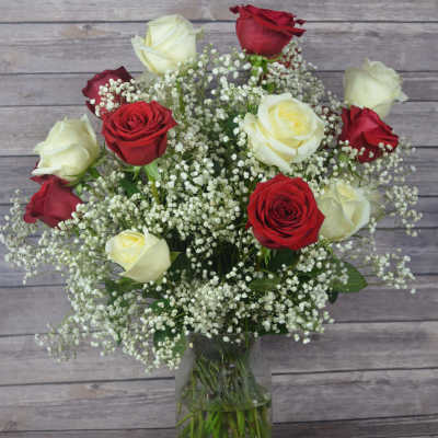 Bouquet of red and white roses in a clear glass vase