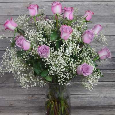 Pink roses and baby's breath in a clear glass vase