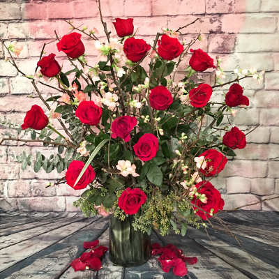 DEVOTED 18 long-stem red roses enhanced with flowering quince blossoms.