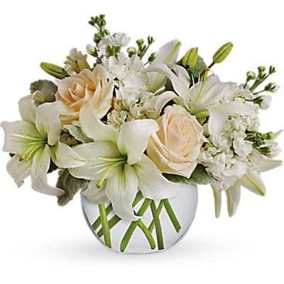 White lilies and cream roses arranged in a round vase