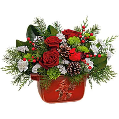 Red roses in a red holiday container with pinecones and berries