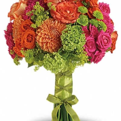 Bouquet of orange, pink, and green flowers tied with a green ribbon