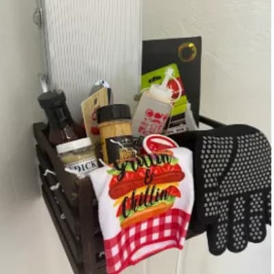 Gift basket with condiments, a towel, and kitchen items