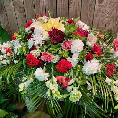 Large red, white, and yellow floral spray with palm fronds
