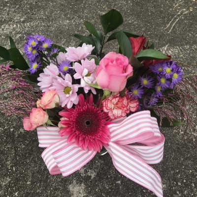 Pink and purple mixed bouquet with a striped ribbon bow