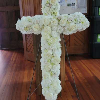 White floral cross on a stand