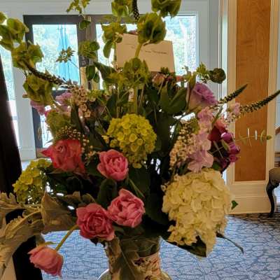 Tall mixed bouquet in a glass vase with pink, white, and green blooms