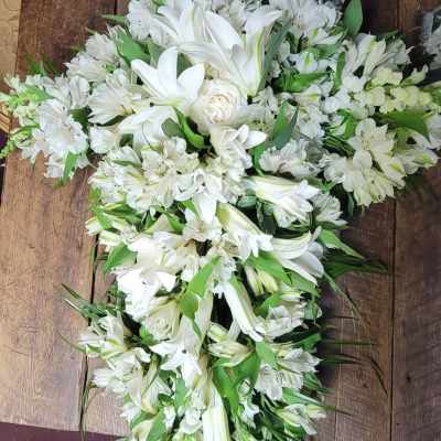 White floral spray with lilies and alstroemeria arranged in a cascading shape