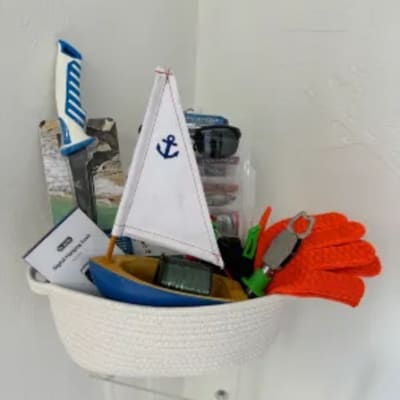 Basket of toy sailboats and nautical accessories