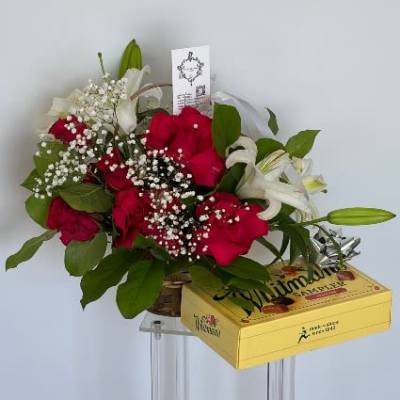 Bouquet of red roses and white lilies with a yellow gift box
