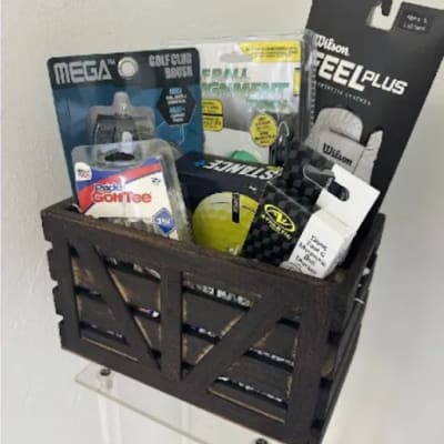 Basket of golf accessories and balls on a wall shelf