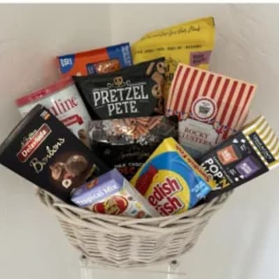 Basket filled with assorted snack boxes and candy packages