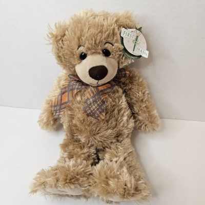 Plush teddy bear with a plaid bow tie and hanging tag
