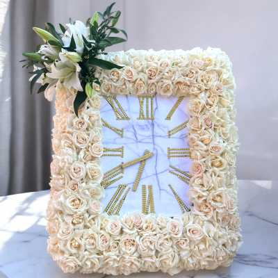 Square floral clock frame with cream roses and lilies around a marble clock face