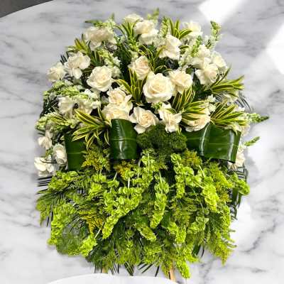 White roses and green flowers in a cascading arrangement