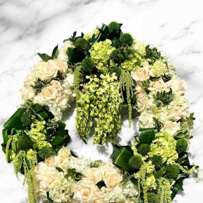 Floral wreath with cream roses and green hydrangeas on a white background