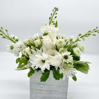 White floral arrangement in a gray square box