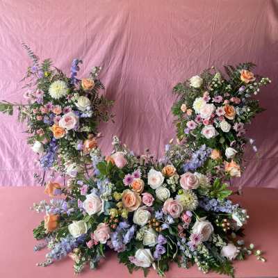 Large floral arrangement with pink, white, peach, and lavender blooms