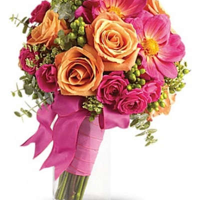 Bouquet of pink and peach roses with pink flowers in a glass vase