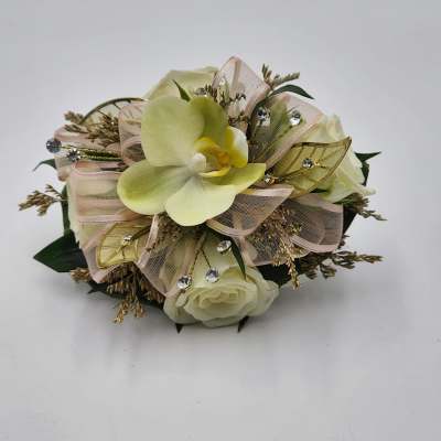 Cream orchid and rose arrangement with ribbon and jeweled accents