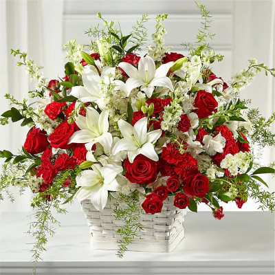 Red roses and white lilies in a white basket