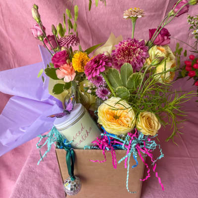 Mixed flower arrangement in a gift box with a candle and hanging ornament