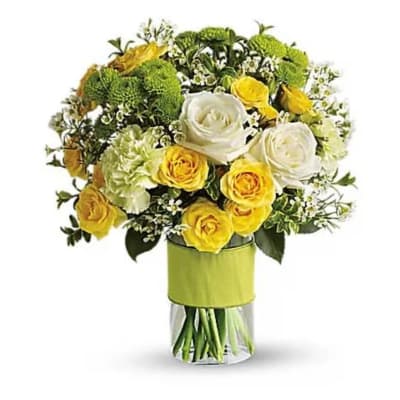 Bouquet of yellow and white roses in a clear glass vase