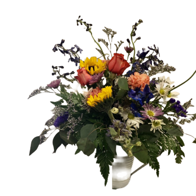Mixed bouquet with sunflowers, roses, and daisies in a white vase