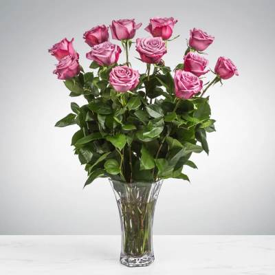 Pink roses arranged in a clear glass vase