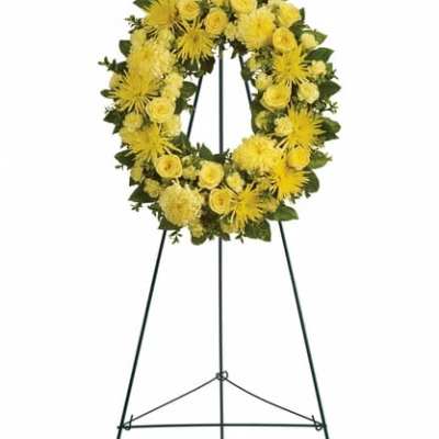 Yellow floral wreath on a black standing easel