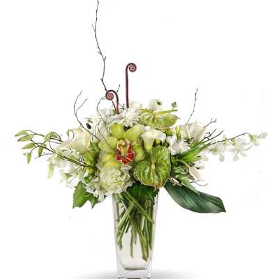 White and green floral arrangement in a clear glass vase