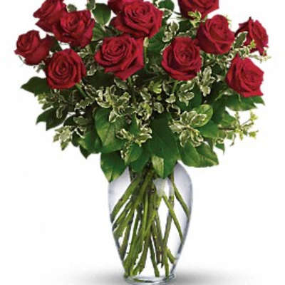 Red roses arranged in a clear glass vase