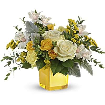 Yellow and white rose bouquet in a yellow glass vase