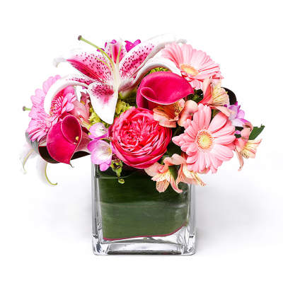 Pink and white mixed flower arrangement in a clear glass vase
