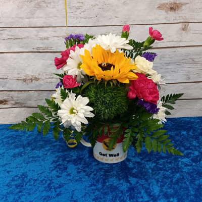 Mixed bouquet in a white "Get Well" container with a large yellow sunflower