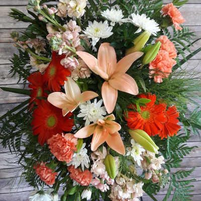 Mixed bouquet with orange gerberas, peach lilies, and white daisies