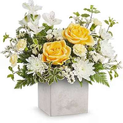 Yellow roses and white flowers in a silver square vase