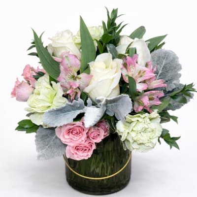 Pink and white roses with alstroemeria in a glass vase